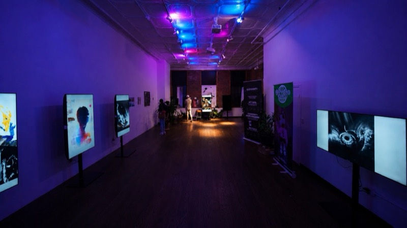 Evening gallery event in the Tribeca loft with screens on stands