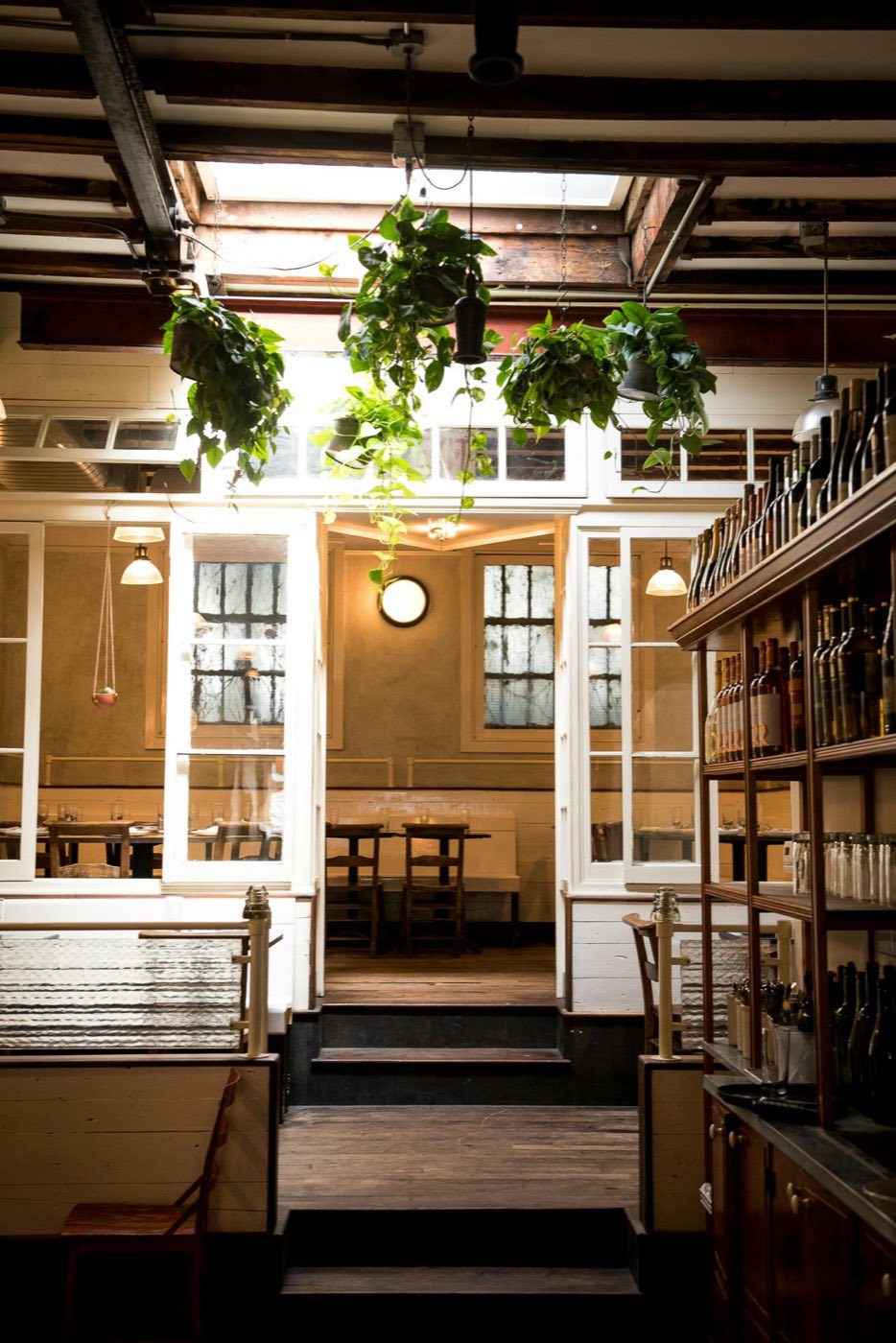 View from the dining room toward the skylit back room and bar shelves