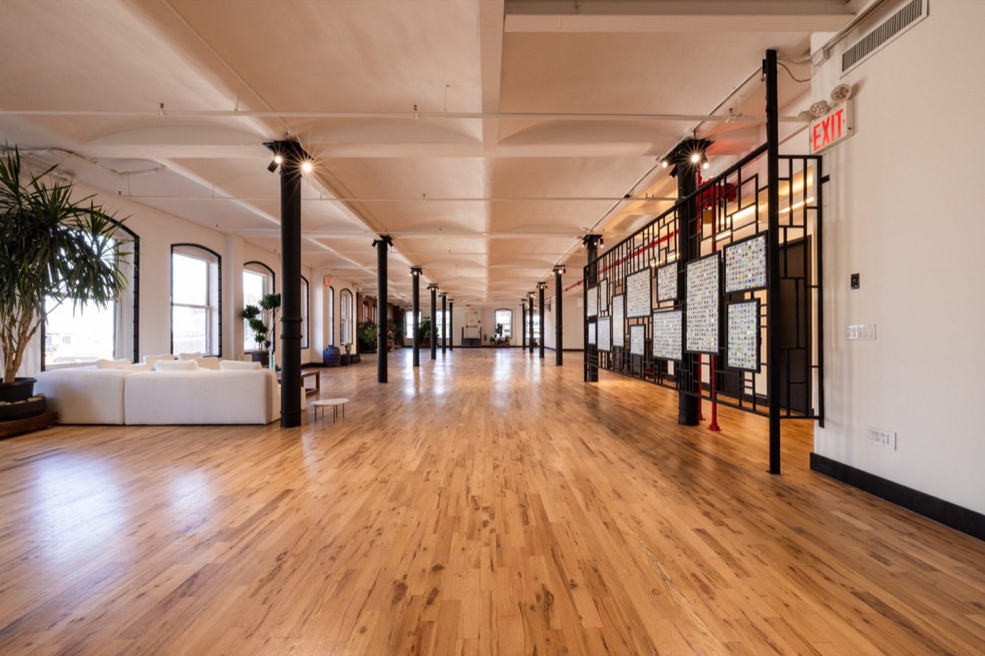Long loft with maple floors, cast iron columns and arched windows