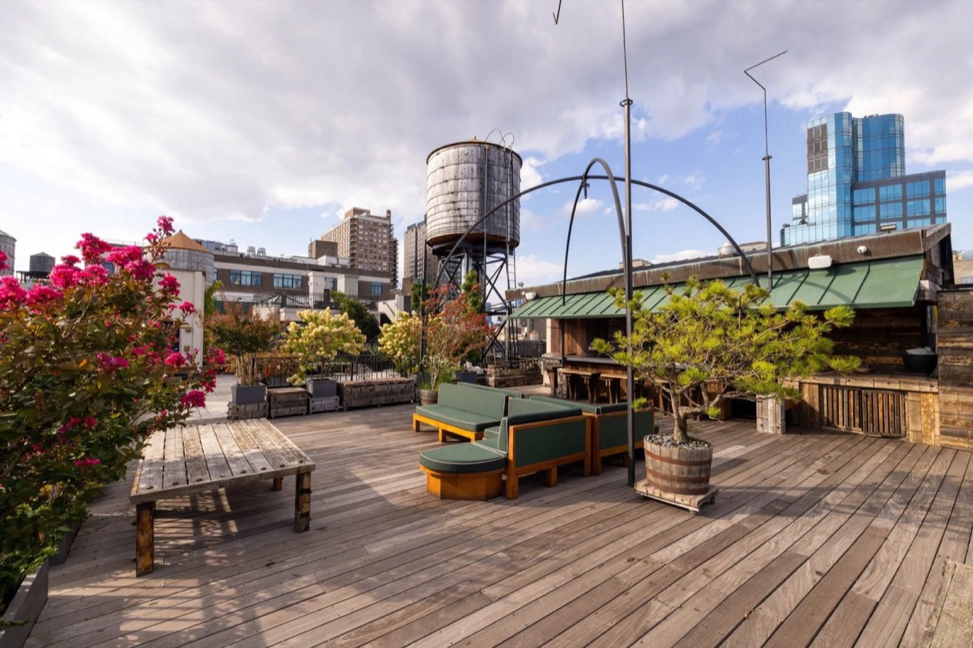 Rooftop deck with lounge seating, planters and water tower views