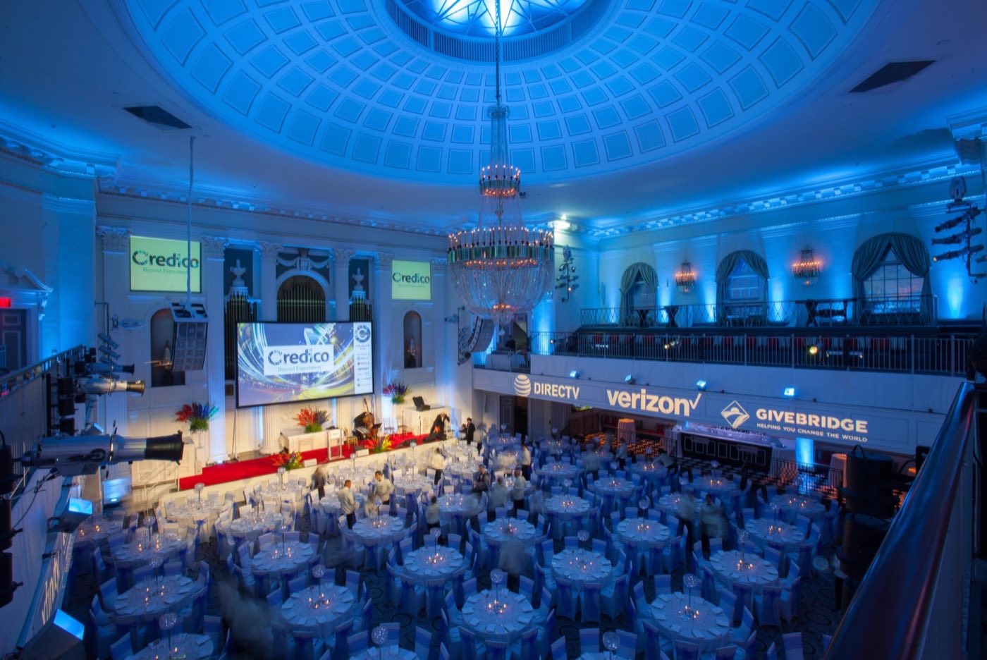 Grand Ballroom set for a seated dinner under the domed ceiling, seen from the balcony