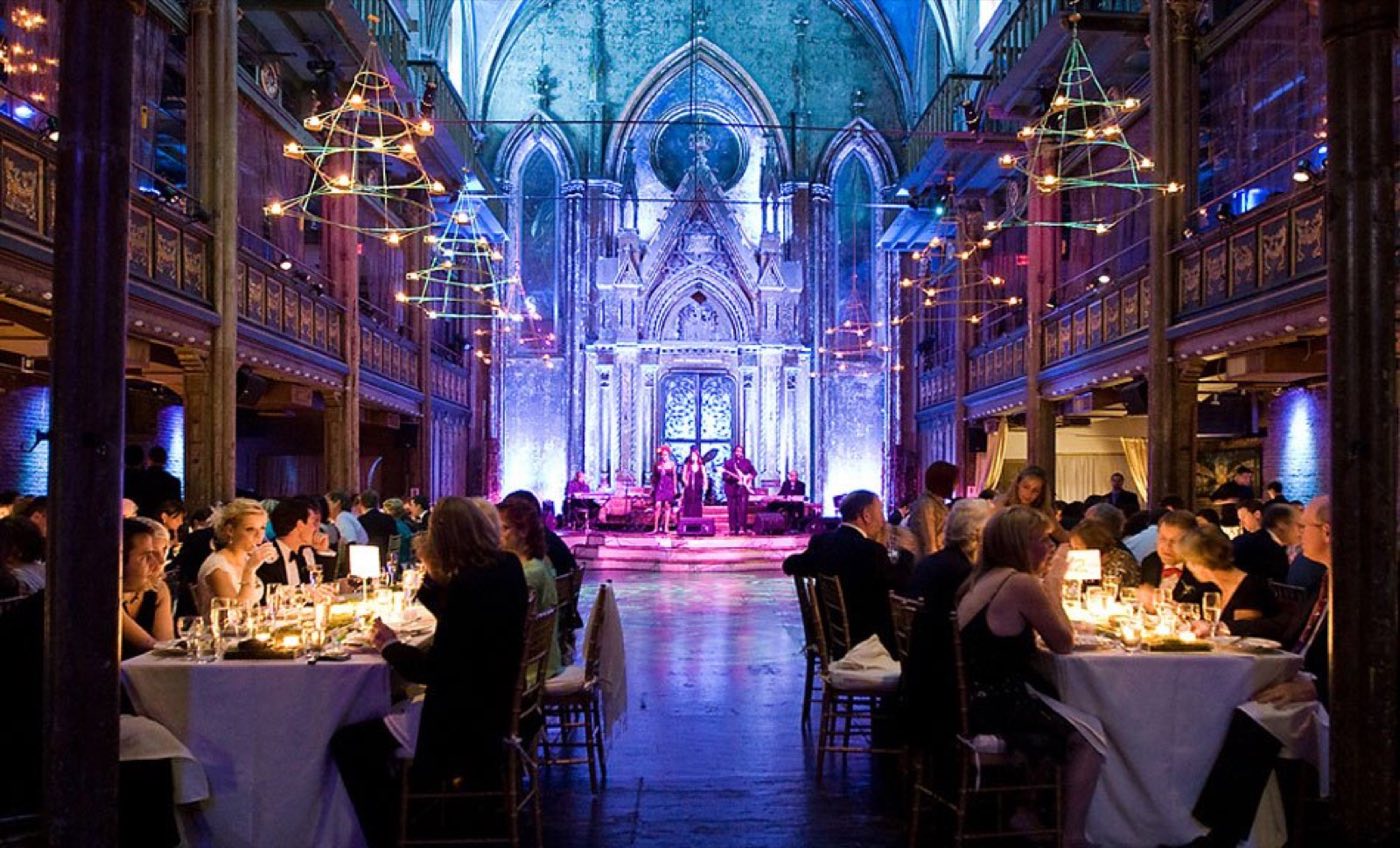 Seated dinner in the main hall with a band on the stage