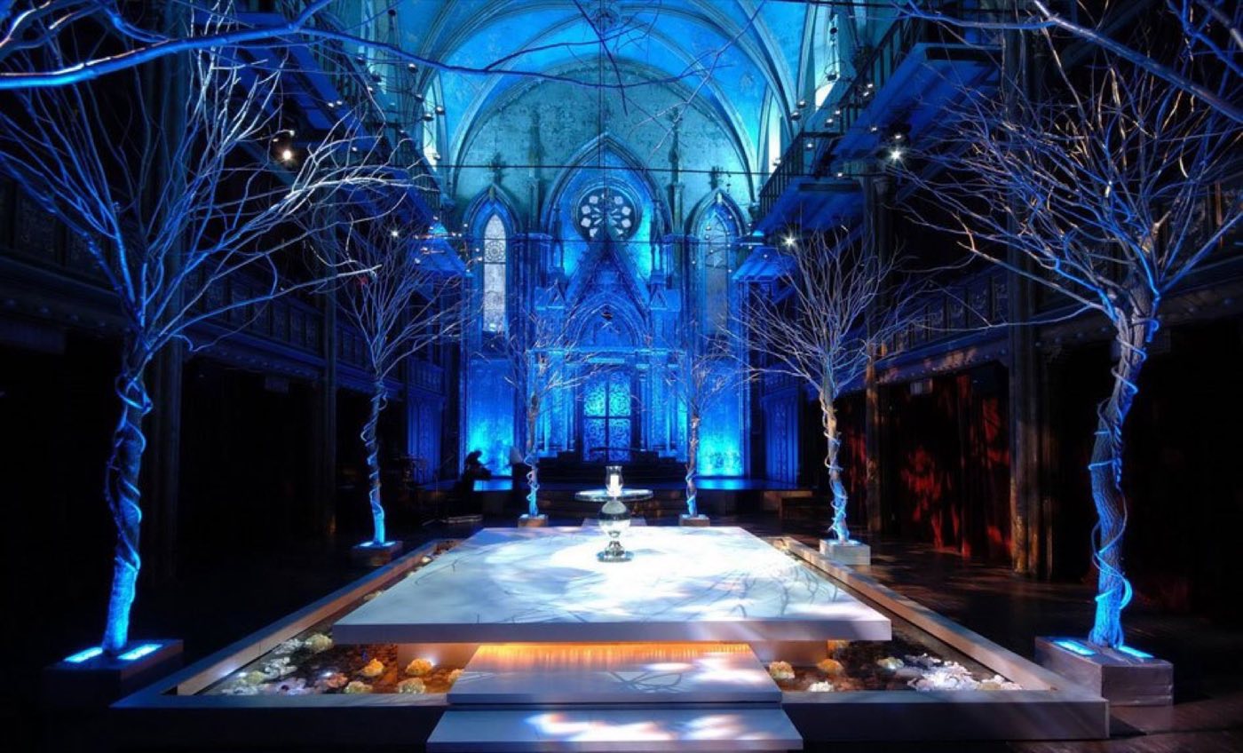Main hall with white branch trees around a raised platform