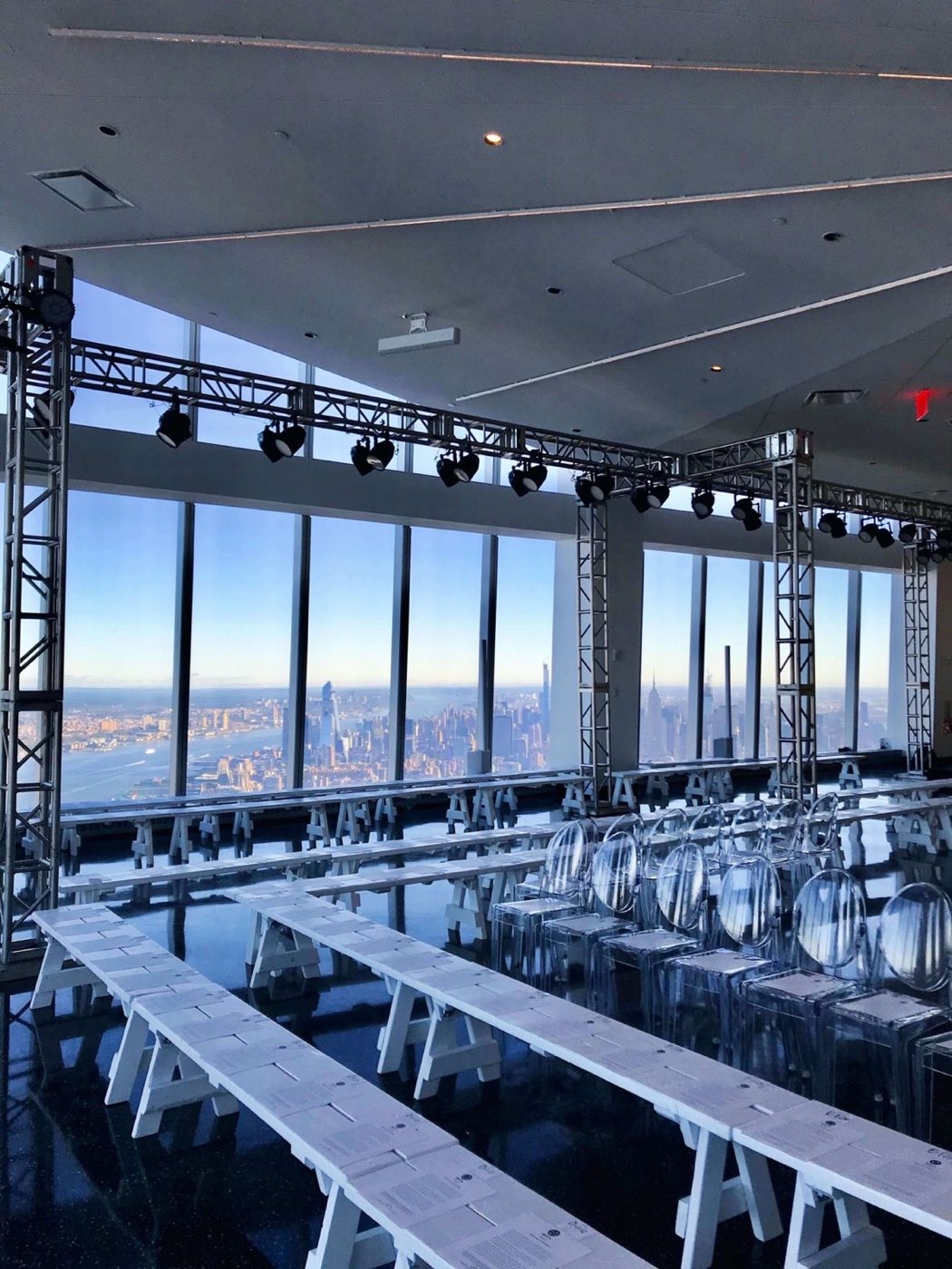 Runway seating set along the windows with overhead lighting truss