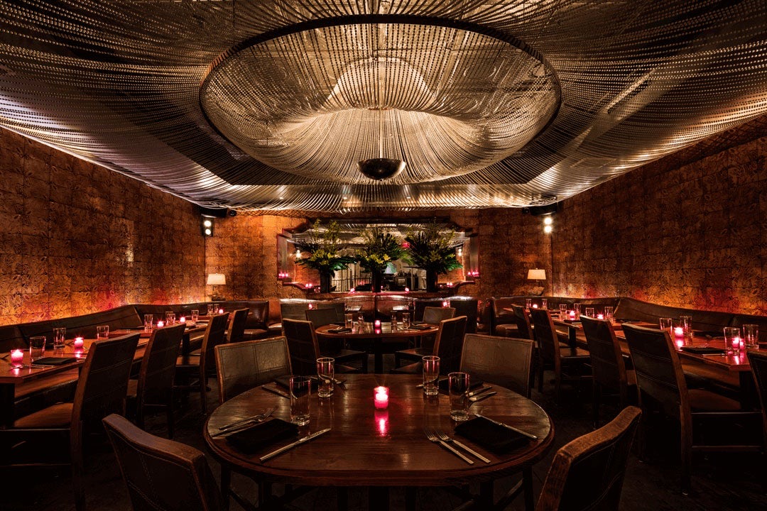 Second floor Pearl Room set with round tables under a large pearl chandelier