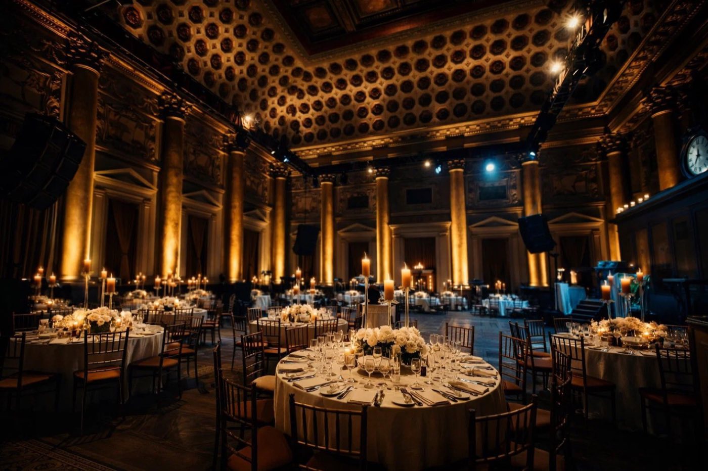 Ballroom set with round dinner tables under the coffered ceiling