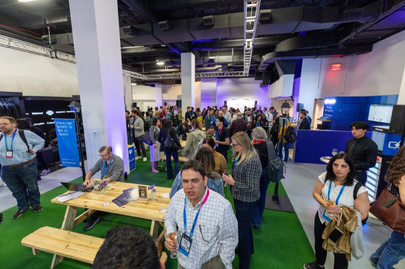 Expo floor with booths, picnic tables and attendees