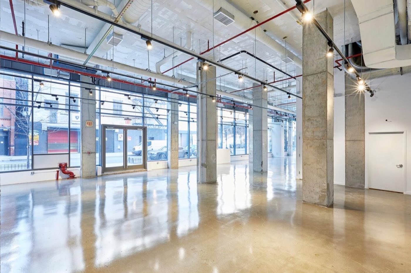 Street level space with floor to ceiling windows and polished concrete
