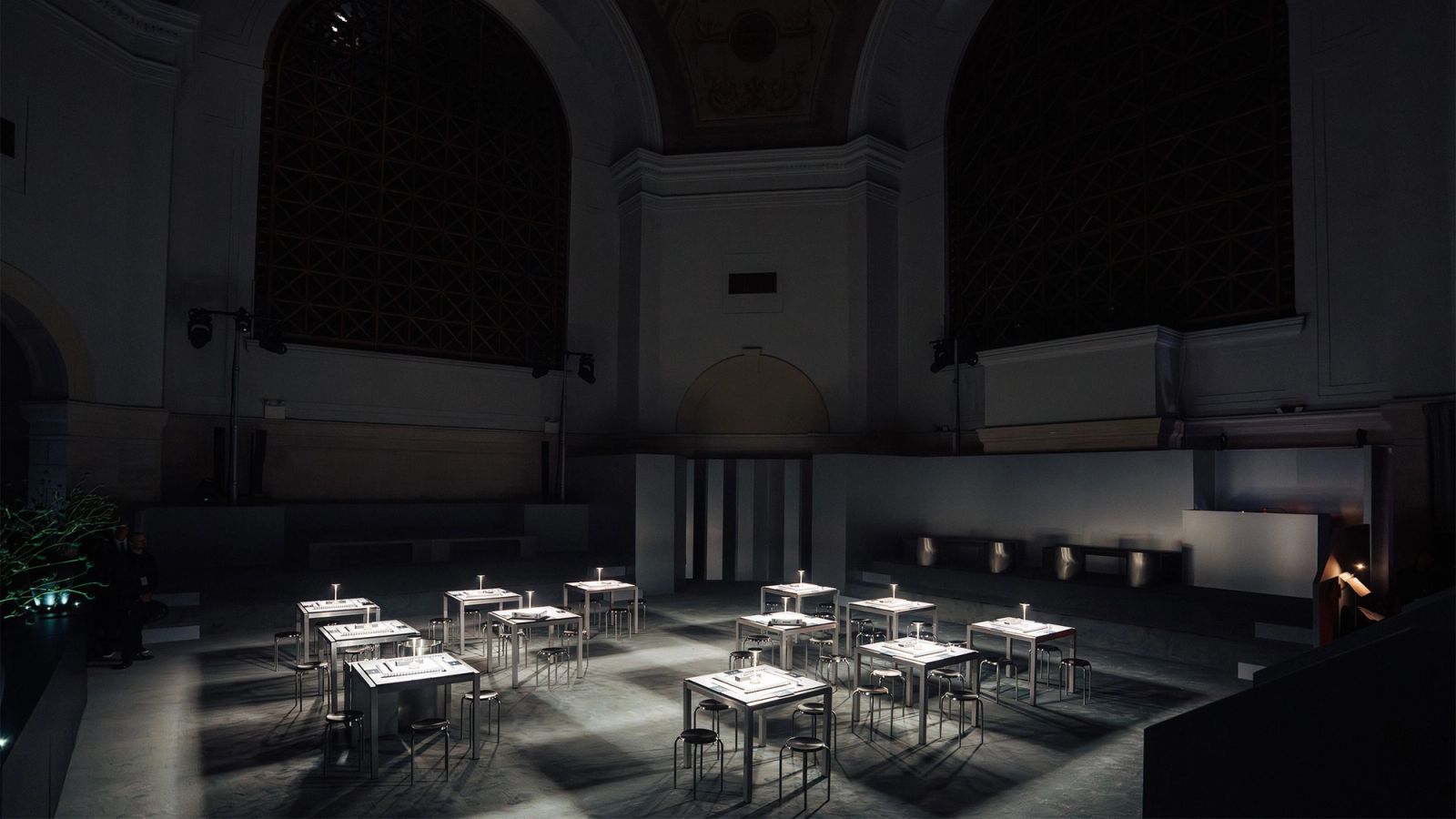 Domed banking hall with arched windows set with small dinner tables