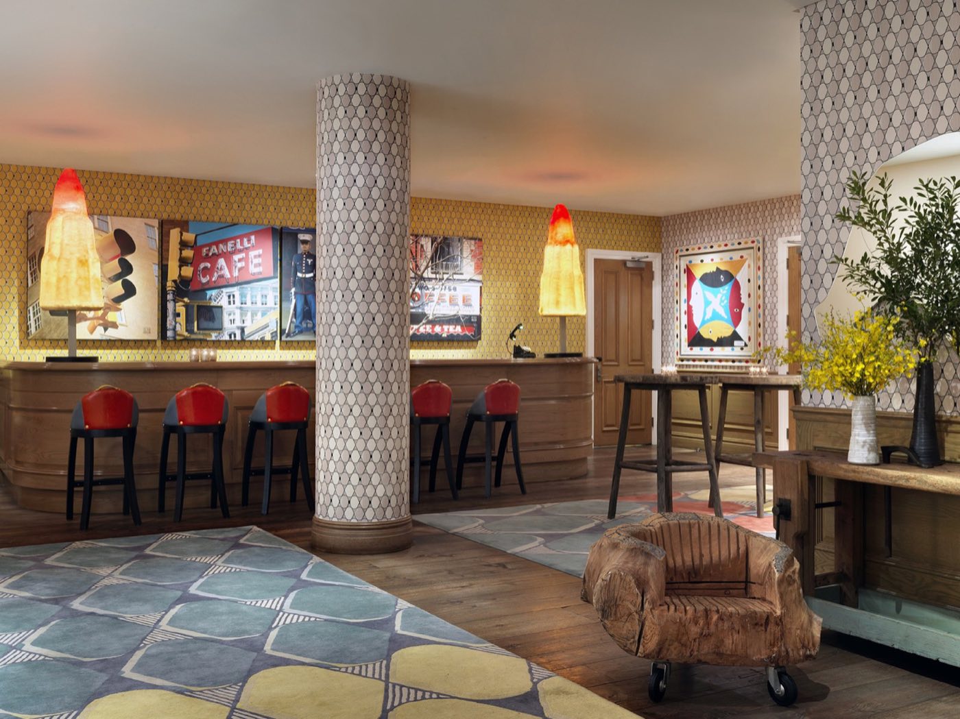 Events lobby with a bar counter, patterned rug, columns and colorful artwork