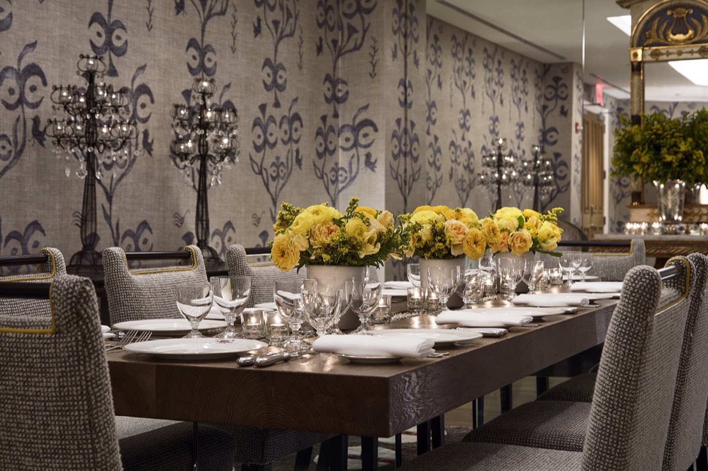 Lafayette room with a long boardroom table set for dinner beneath candelabras