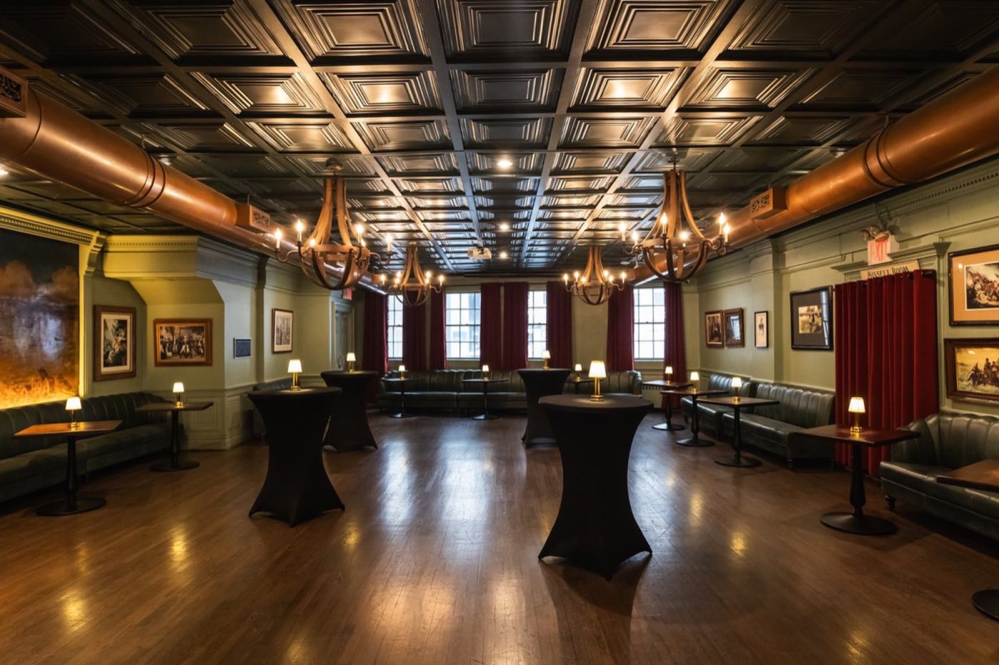 Bissell Room at Fraunces Tavern with cocktail tables, chandeliers and a long banquette