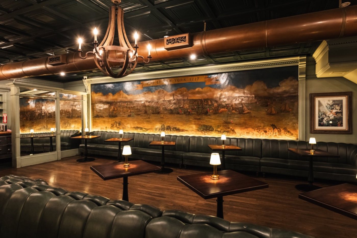 Painted historical mural above green leather banquettes in the Bissell Room