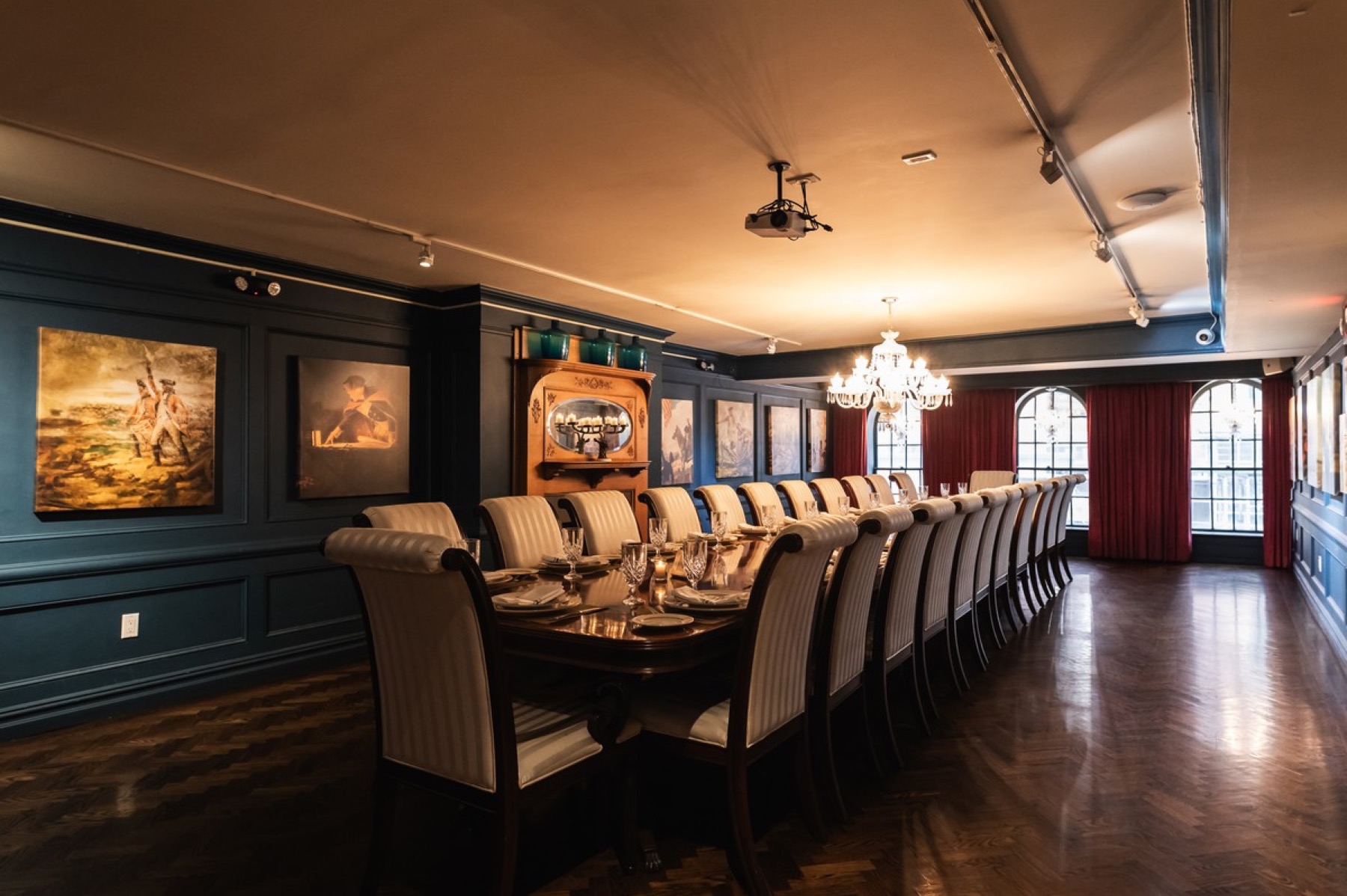 Washington Room set for a long seated dinner under a crystal chandelier