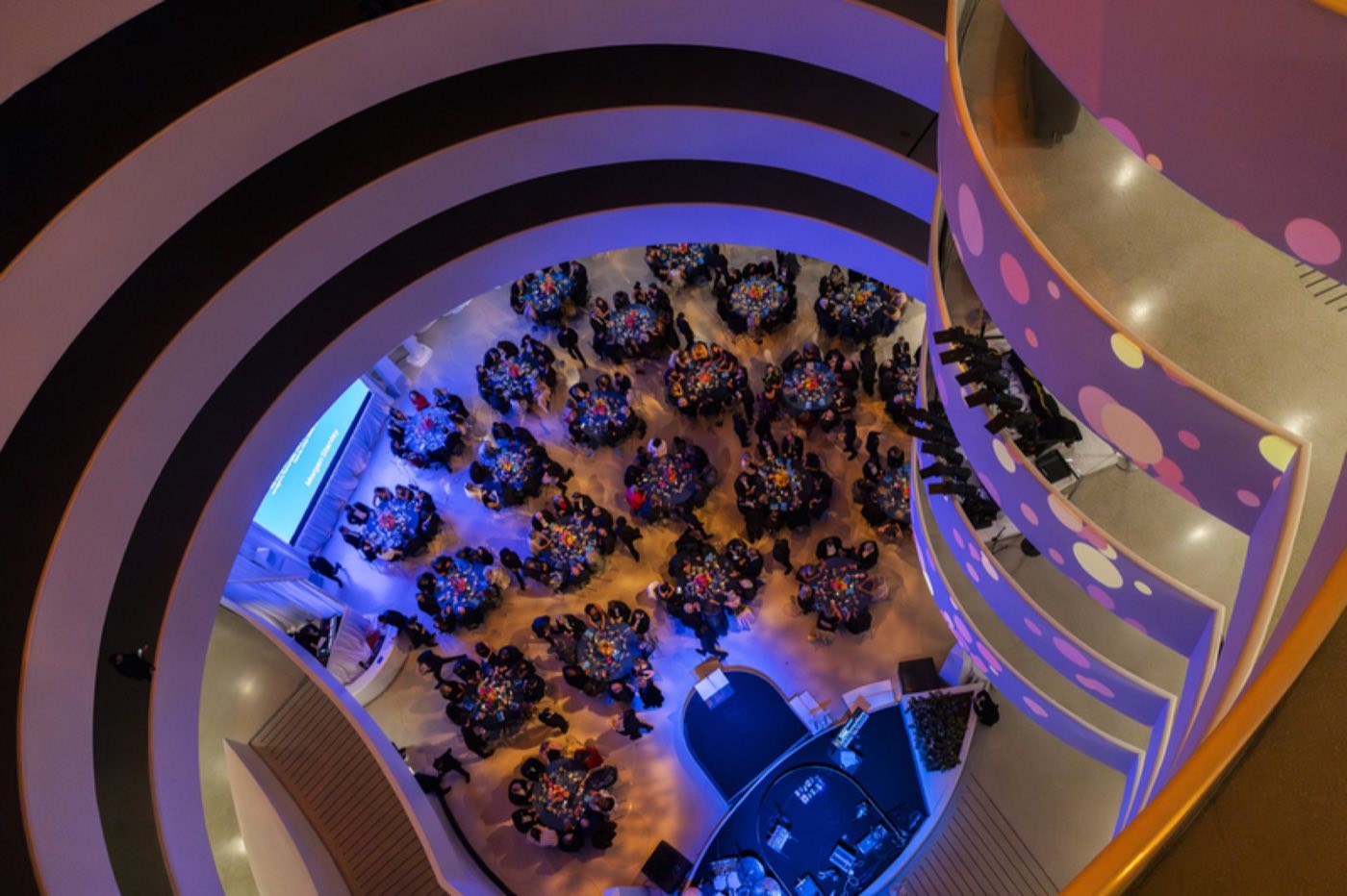 Rotunda floor set with round dinner tables seen from the ramps above