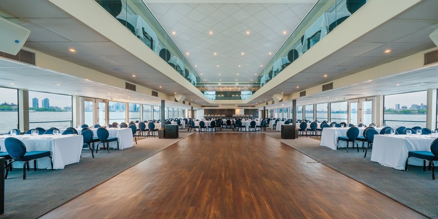Long First Deck interior with a wood dance floor and window walls