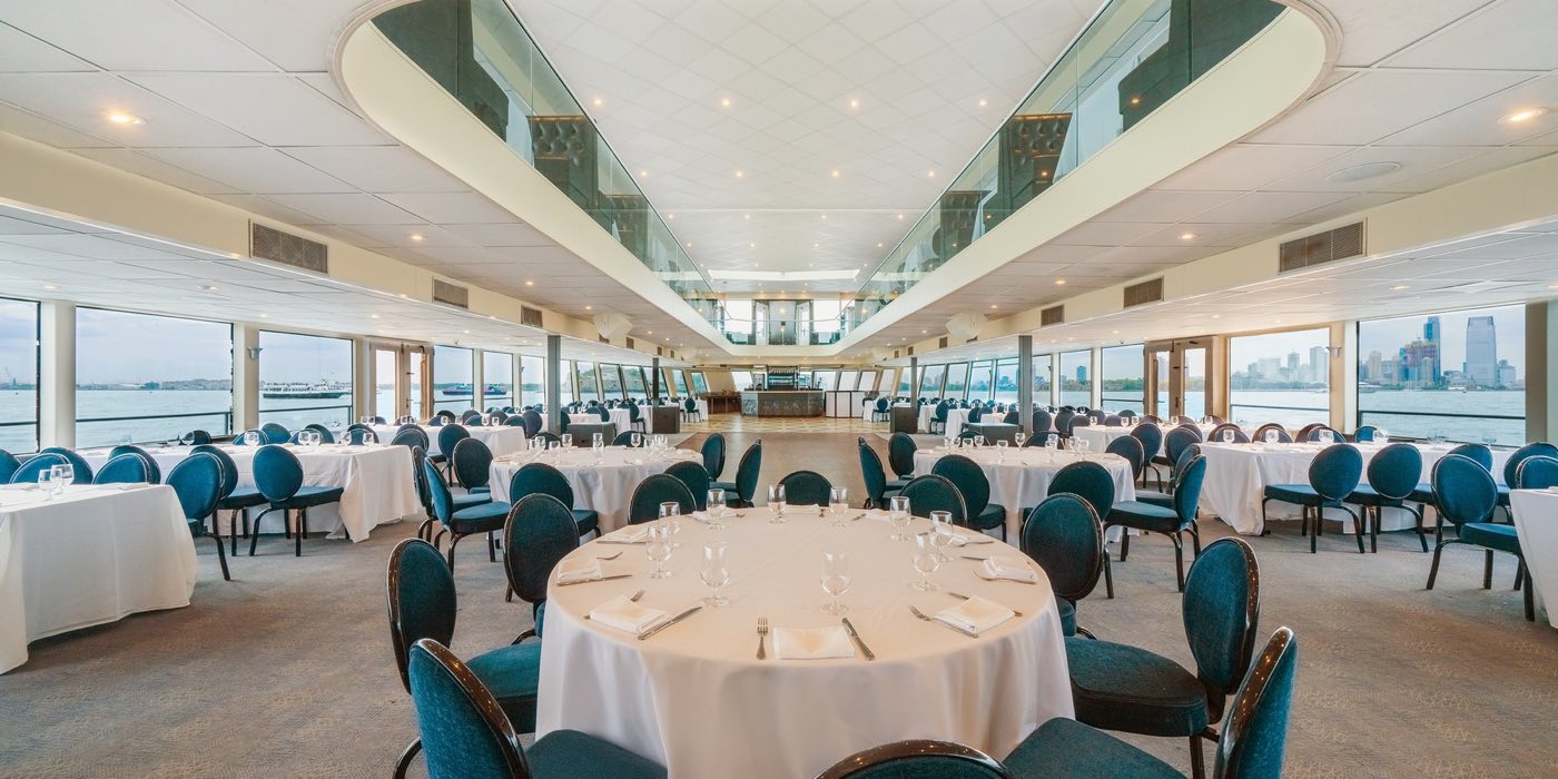 First Deck set with round dinner tables along floor-to-ceiling windows