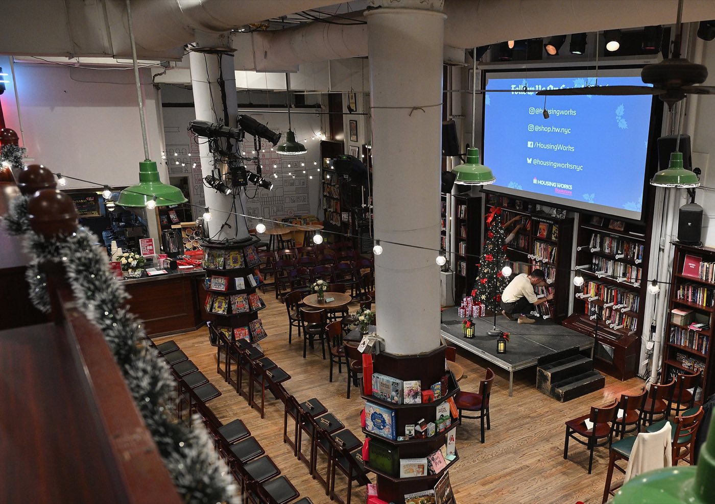 Bookstore main floor set theater style facing a small stage and screen