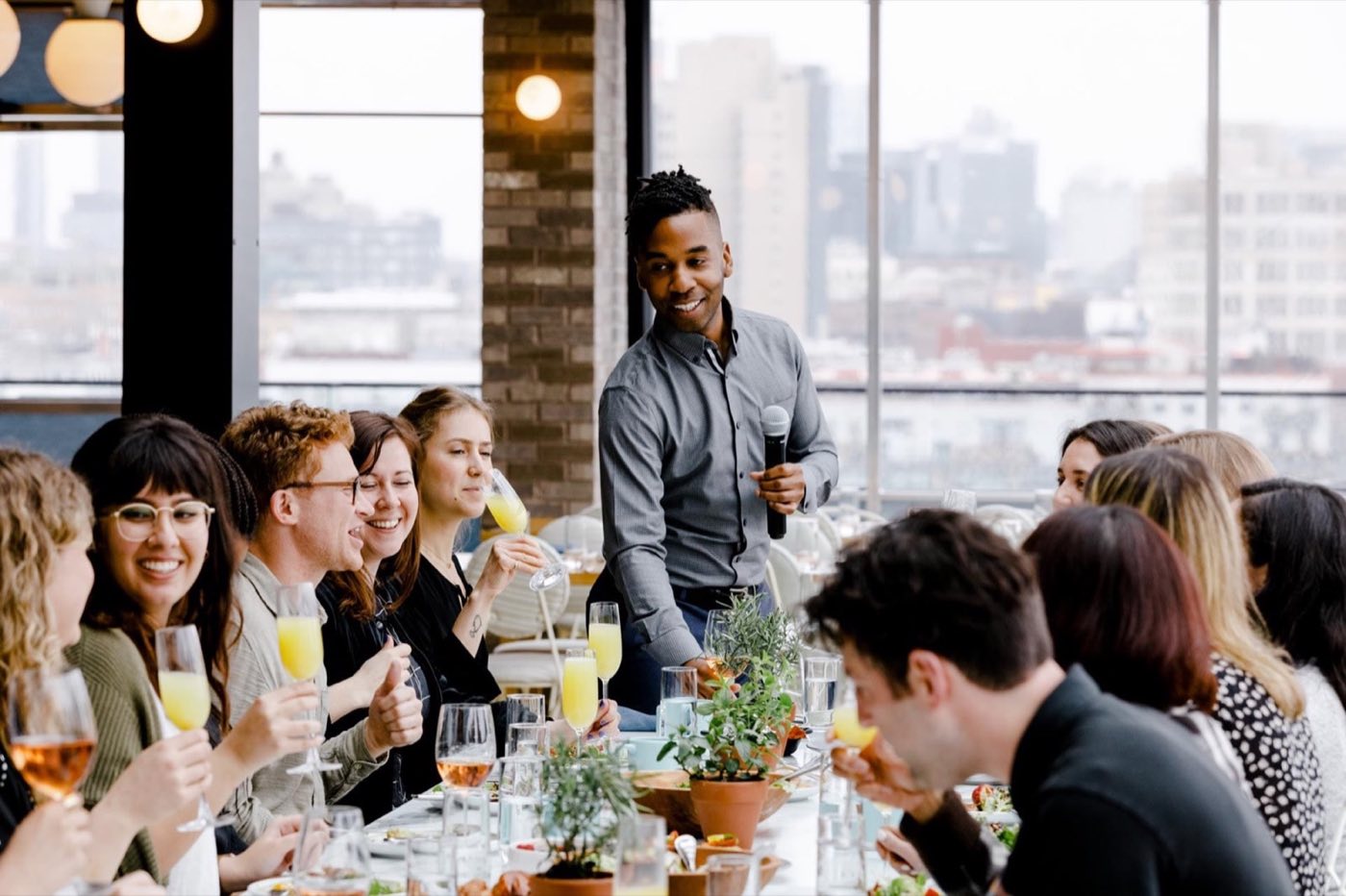 Group dinner by the windows with the city view behind