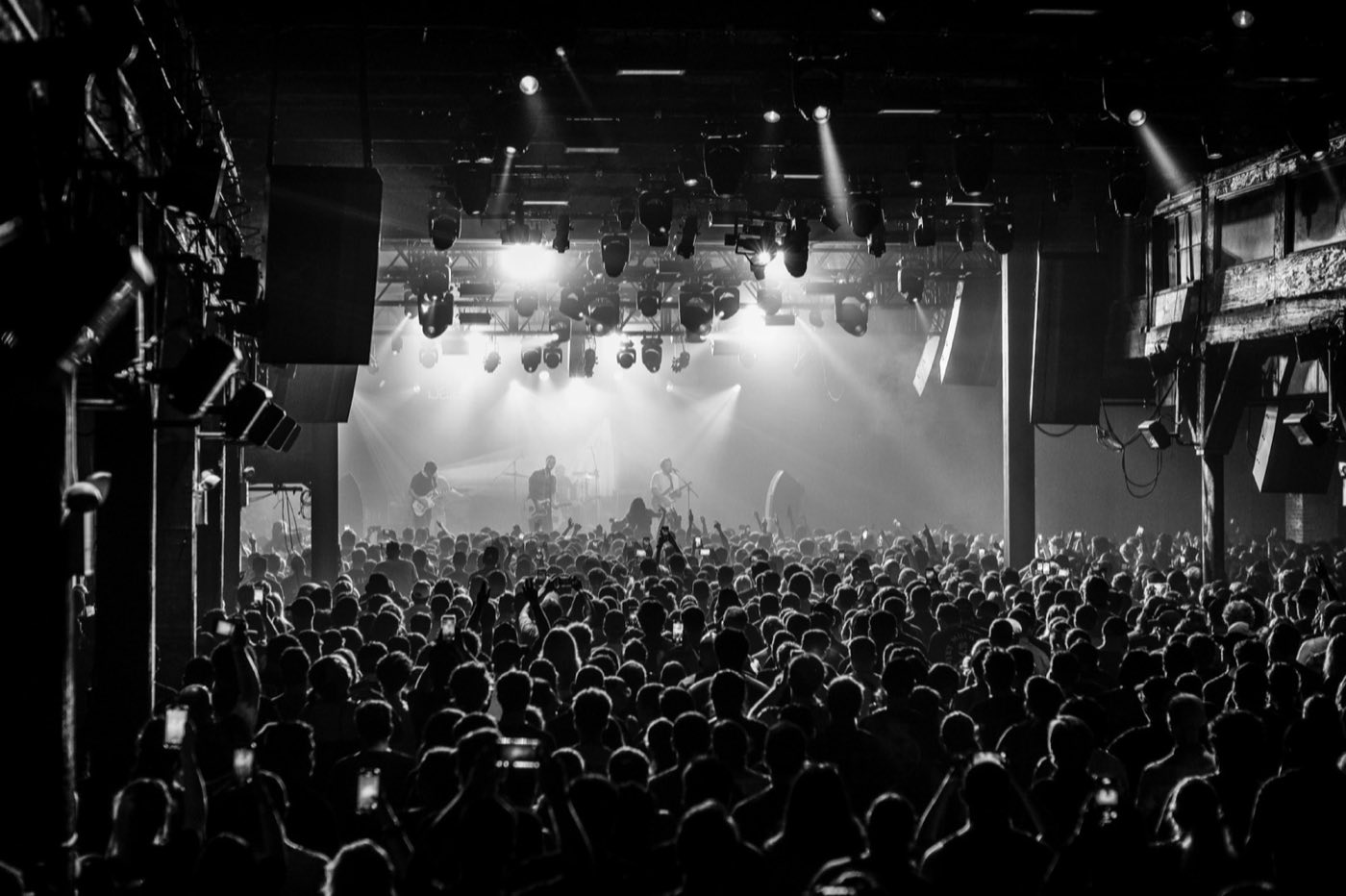 Main hall in black and white, stage lighting across the wide open floor