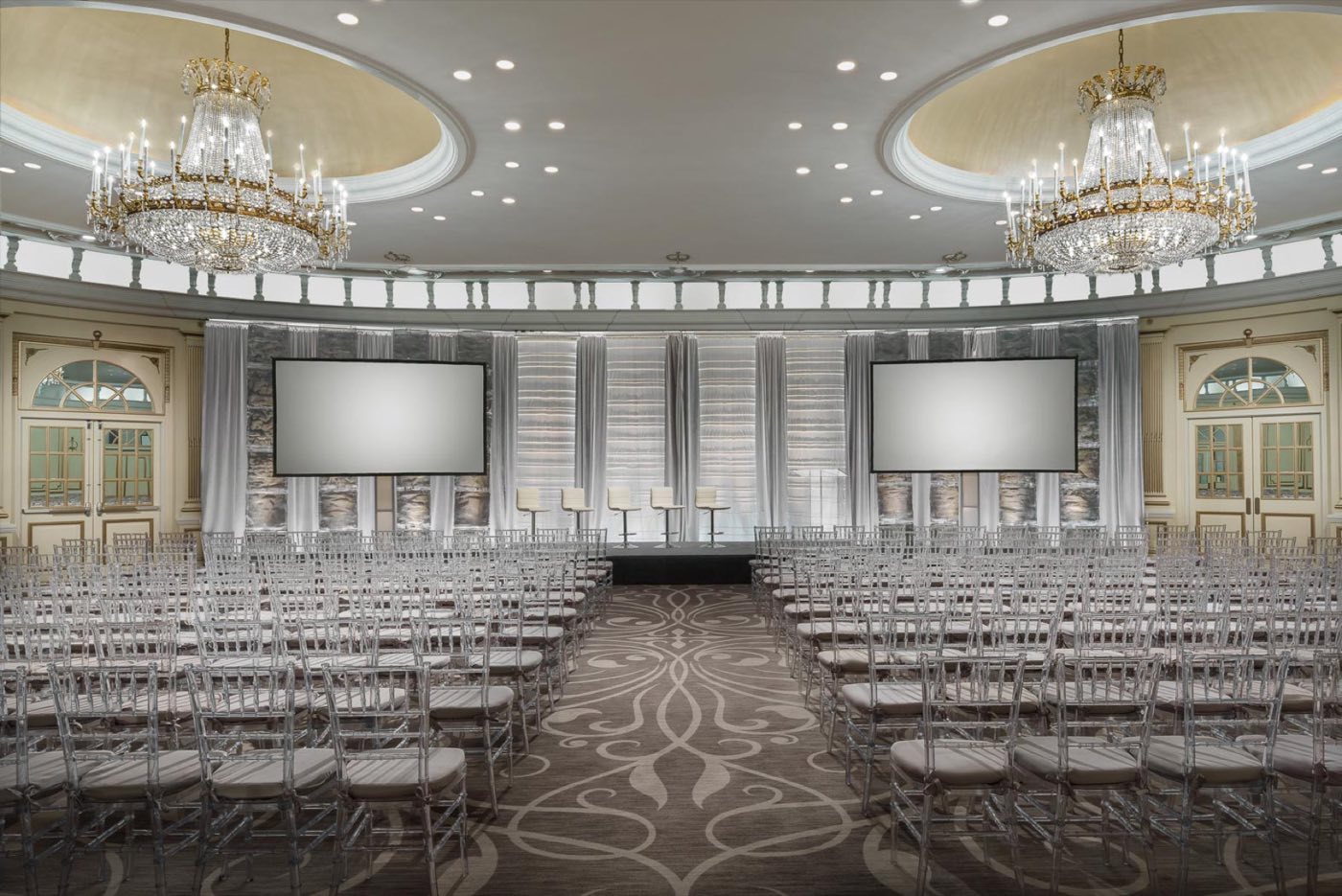 Villard Ballroom in theater rows facing a stage with twin projection screens