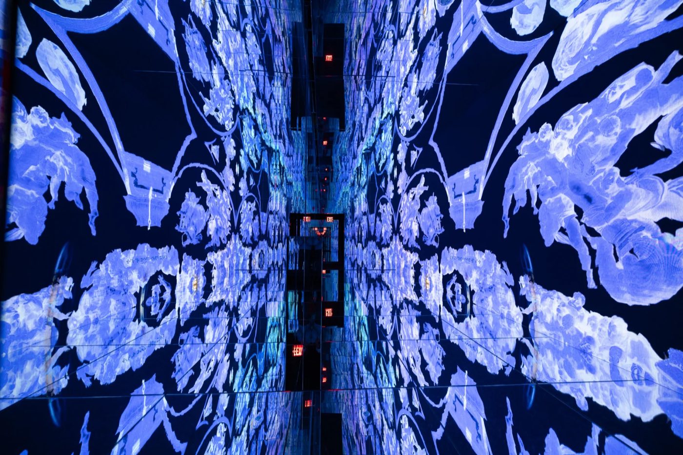 Mirrored corridor lined with blue and white floral LED patterns