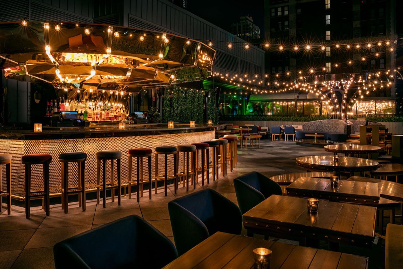 West Terrace at night with the carousel bar, string lights and lounge seating