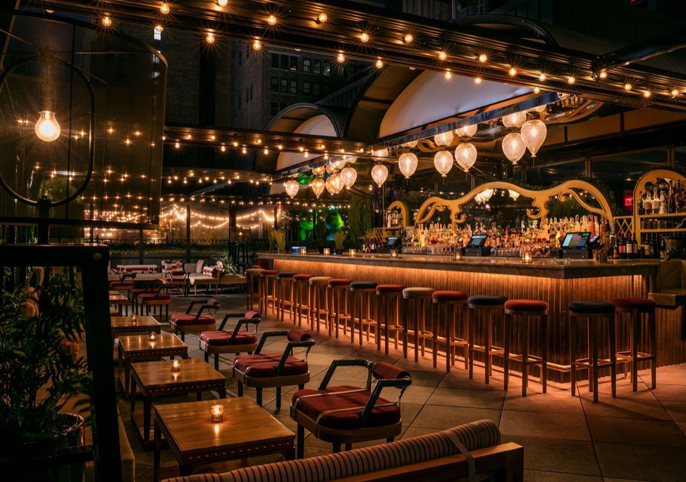 East Terrace bar with lit stools, hanging lamps and table seating