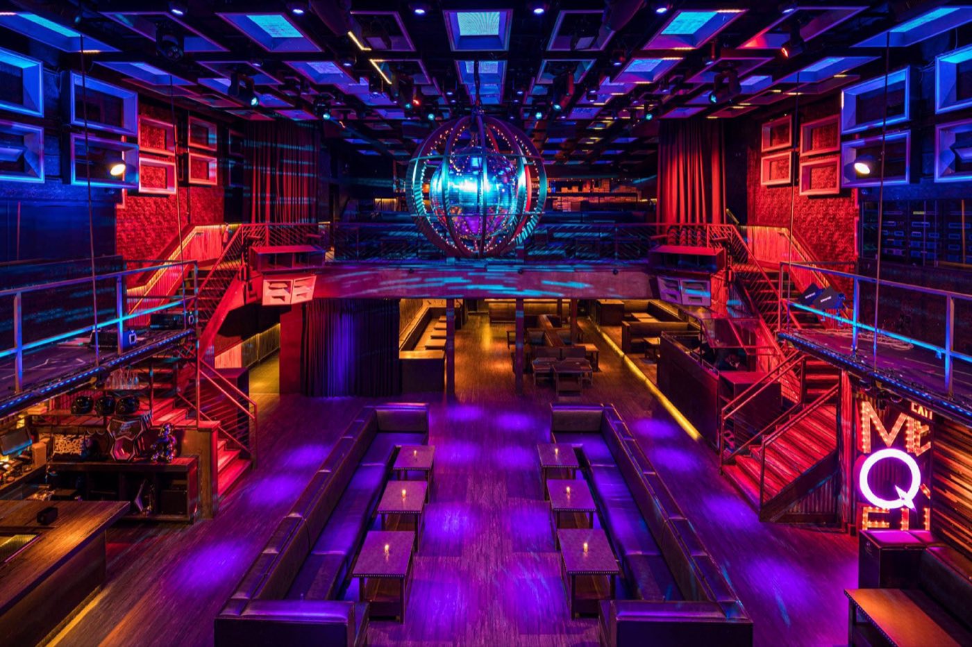 Earlier main room layout viewed from the mezzanine, with purple lighting and a disco sphere