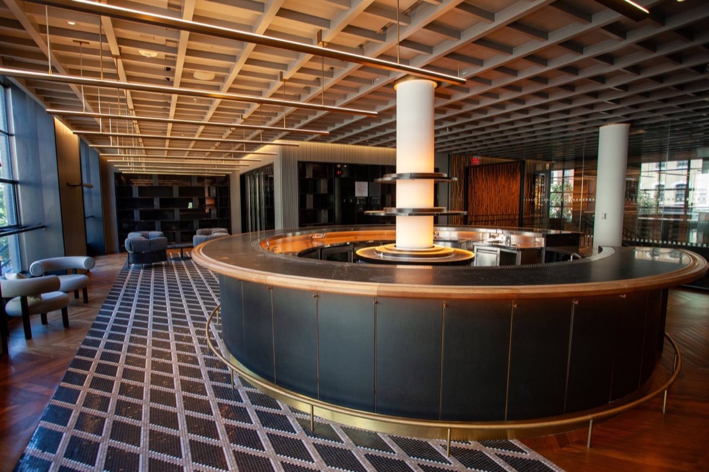 Main floor with a round central bar, coffered ceiling and tiled floor