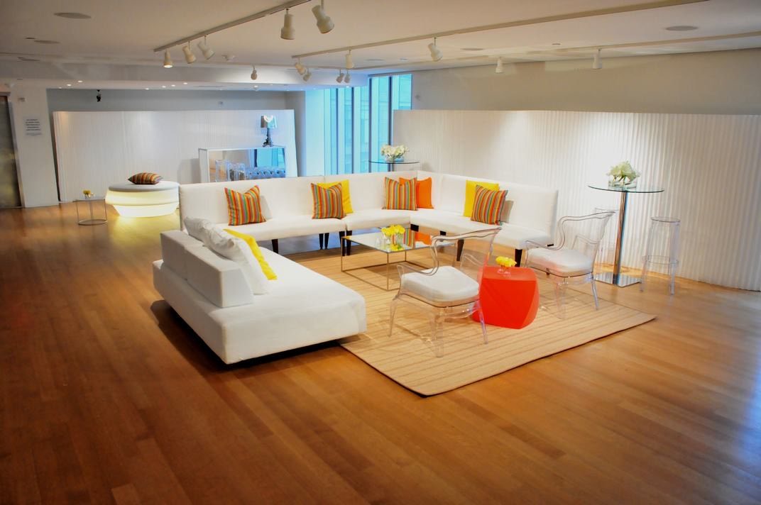 Seventh floor lounge with white sofas, rug and wood floor