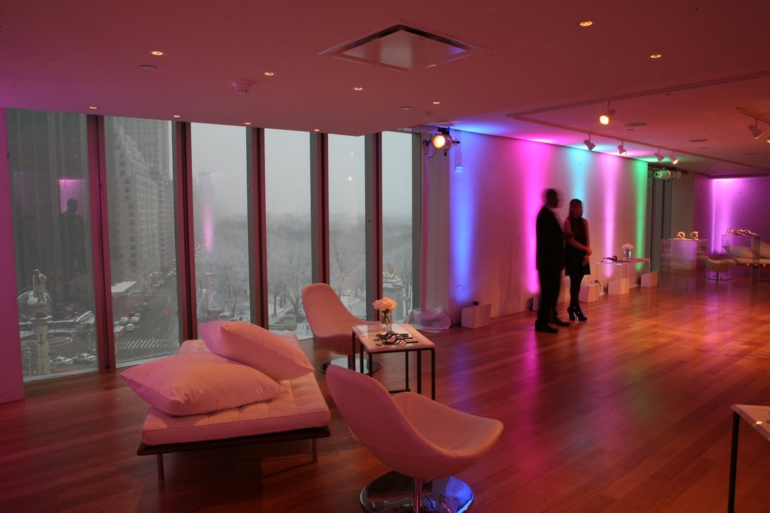 Seventh floor with colored uplighting, lounge chairs and city windows