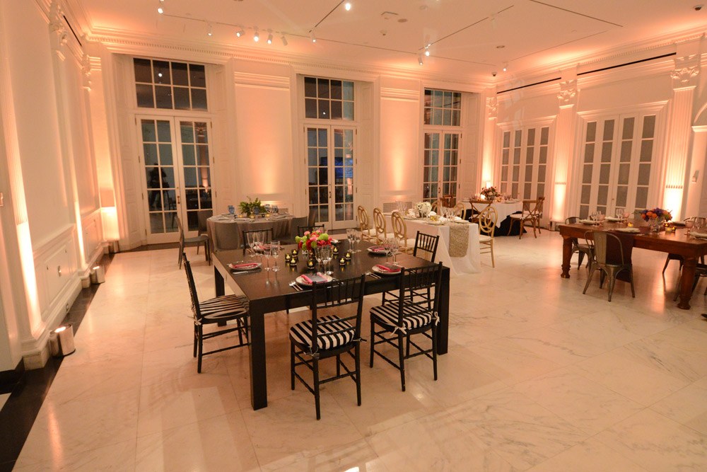 Marble Court with warm uplighting, French doors and small dinner tables