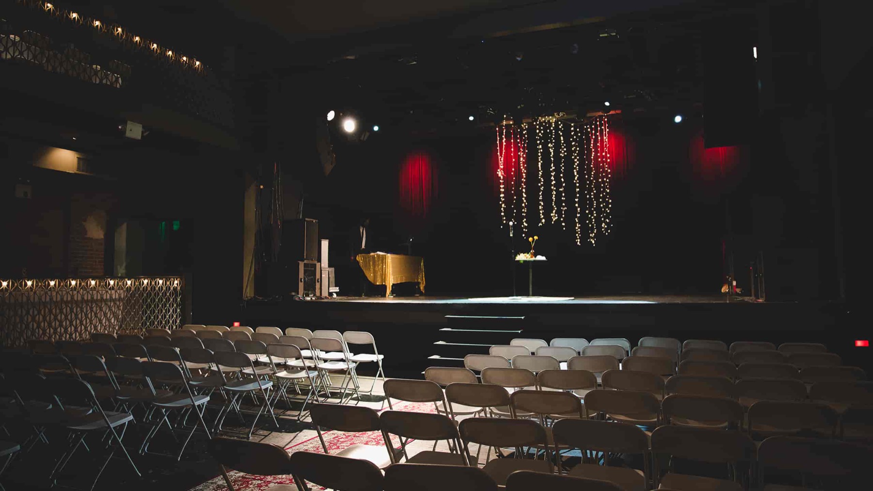 Main floor set with rows of chairs facing the stage for a presentation