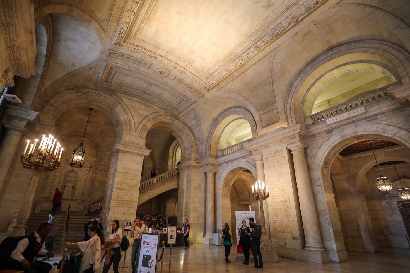 Astor Hall marble entrance hall with vaulted ceiling, arches and candelabra lamps