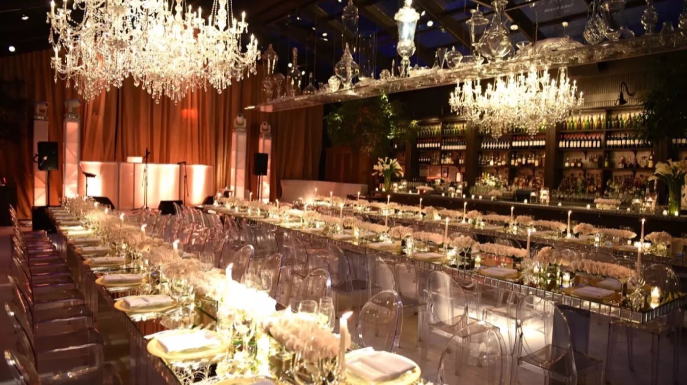 NoMo Kitchen set with long dinner tables under crystal chandeliers and a back bar
