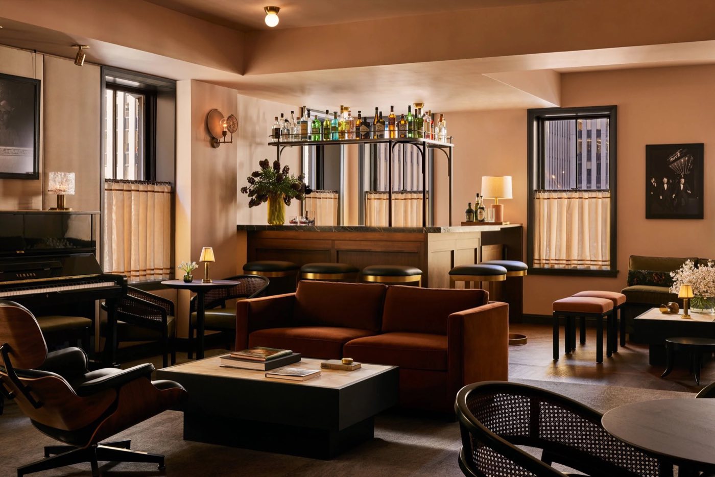 Top-floor private lounge with sofas, a piano and its own bar