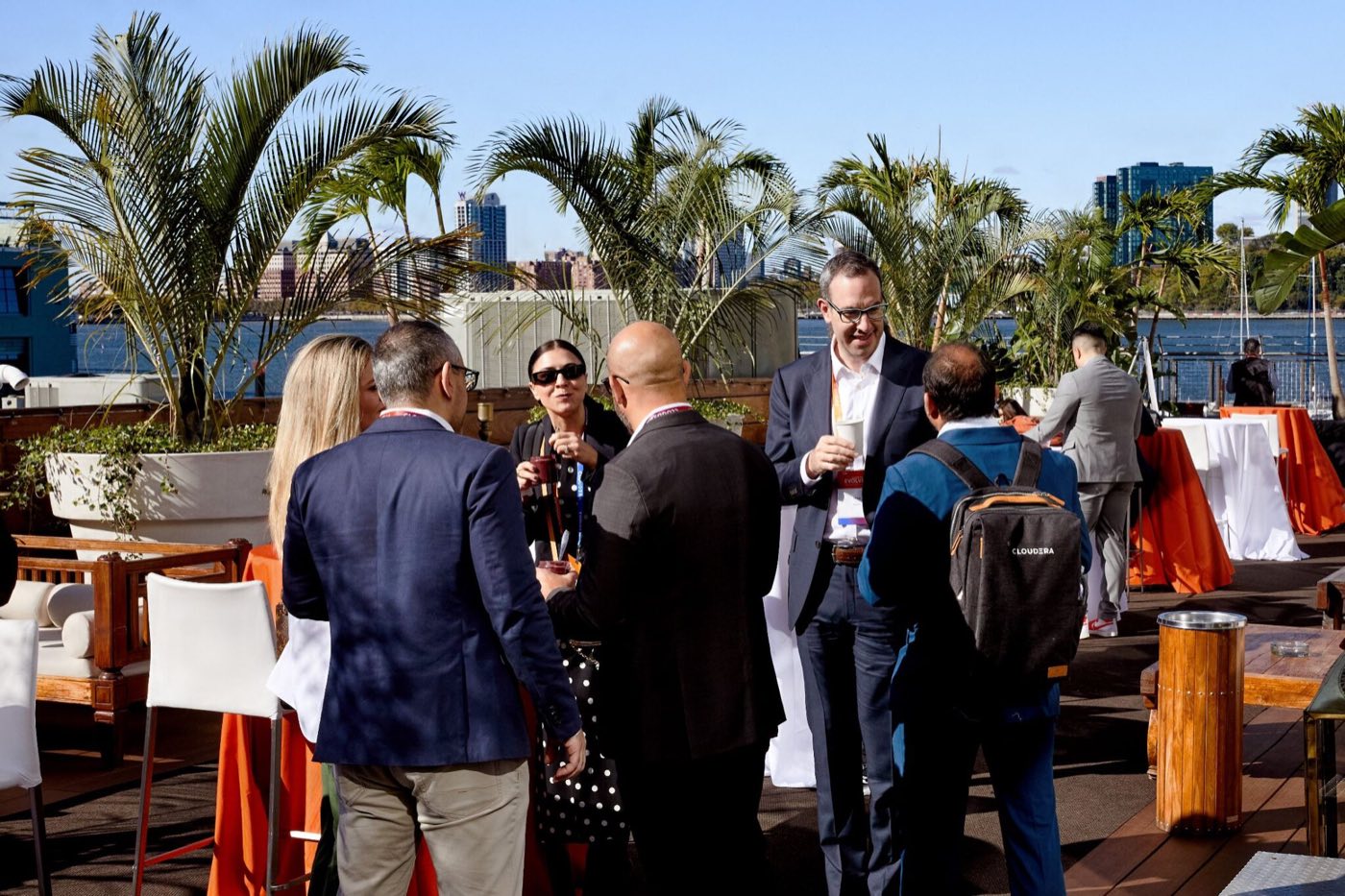 Cocktail reception on the palm-lined deck with the Hudson behind
