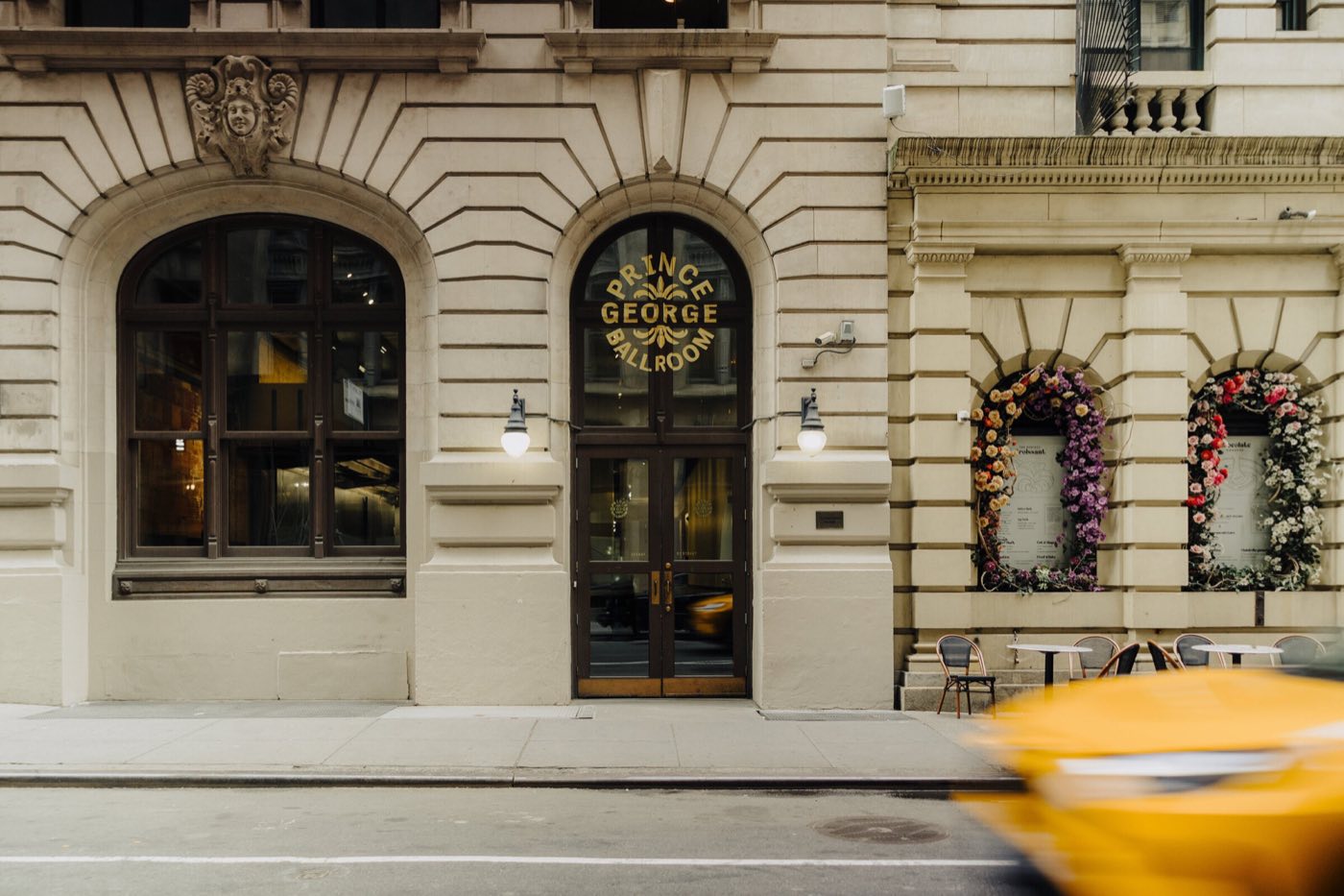 Limestone facade on East 27th Street with arched windows and the ballroom entrance