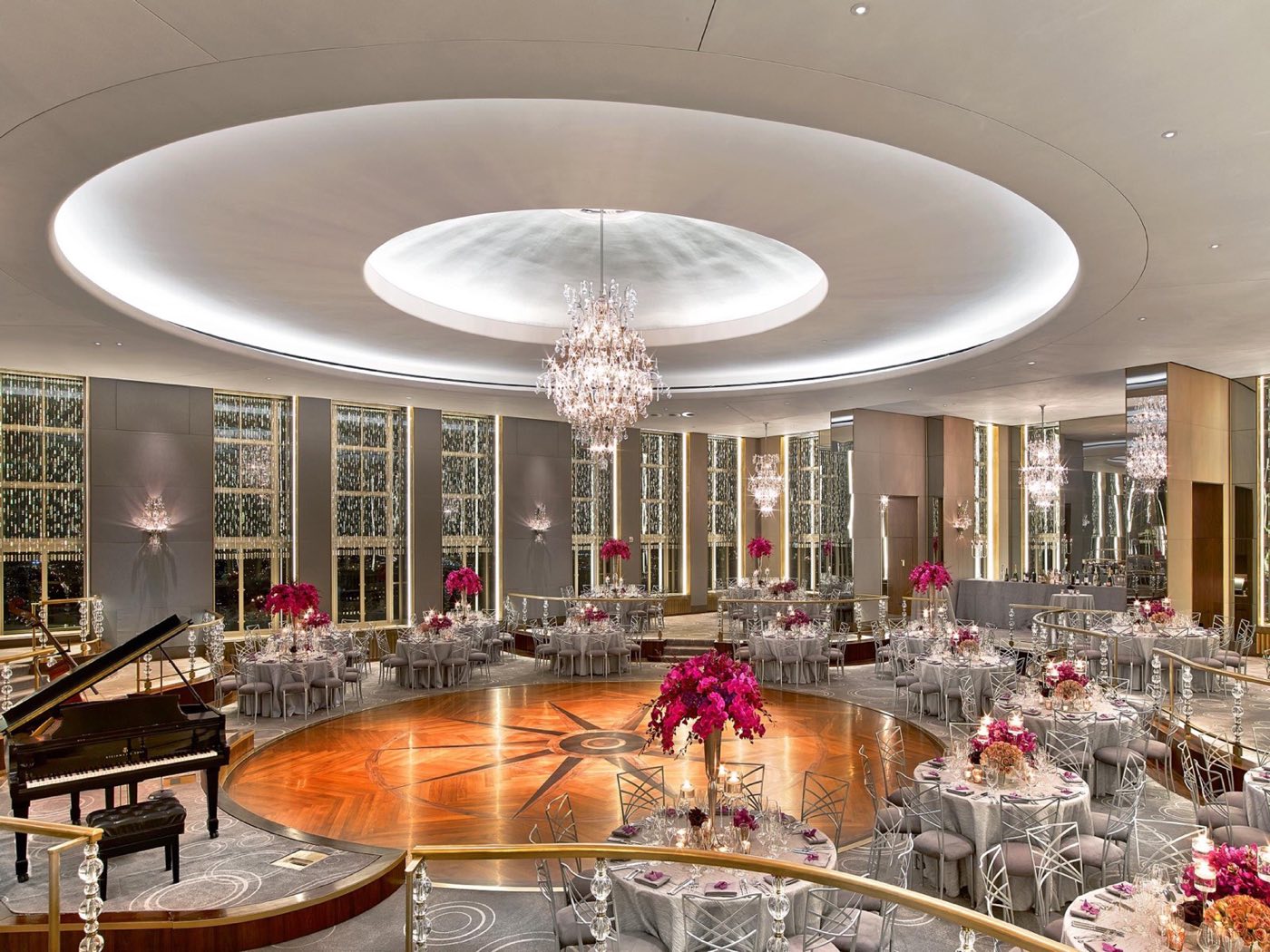 Rainbow Room set for dinner around the round dance floor, with a grand piano and chandelier