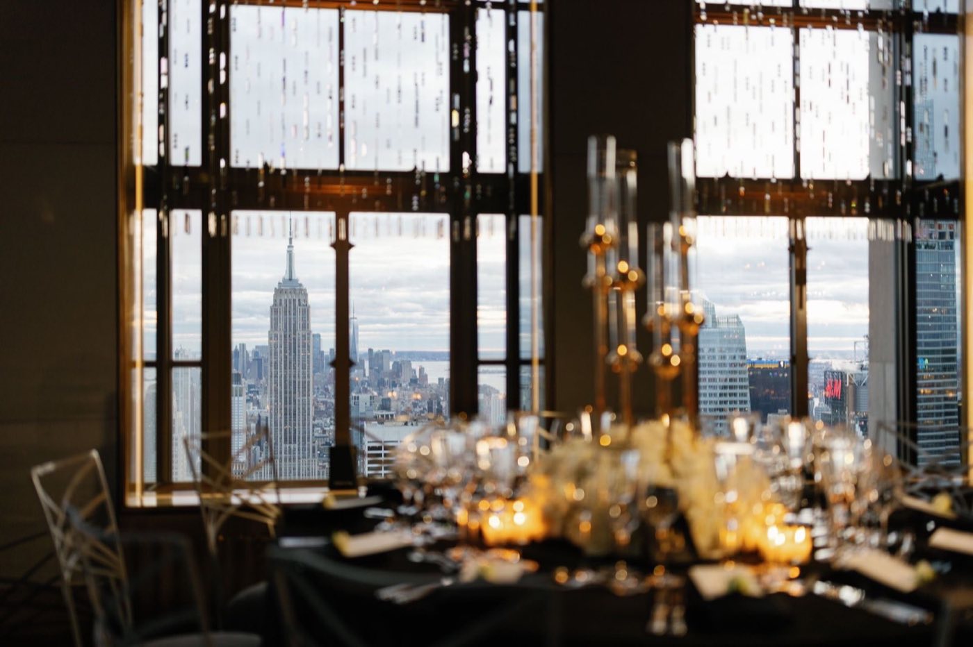 Set dinner table beside a window framing the Empire State Building