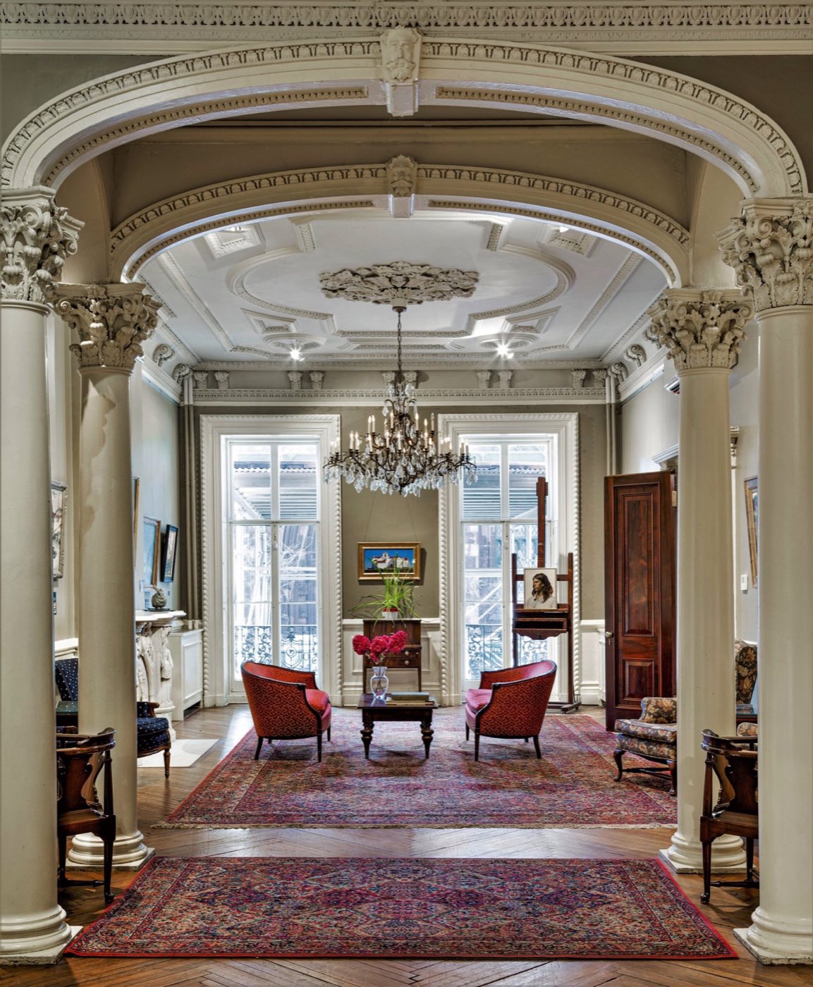 Parlor with Corinthian columns, a plaster ceiling medallion and a crystal chandelier
