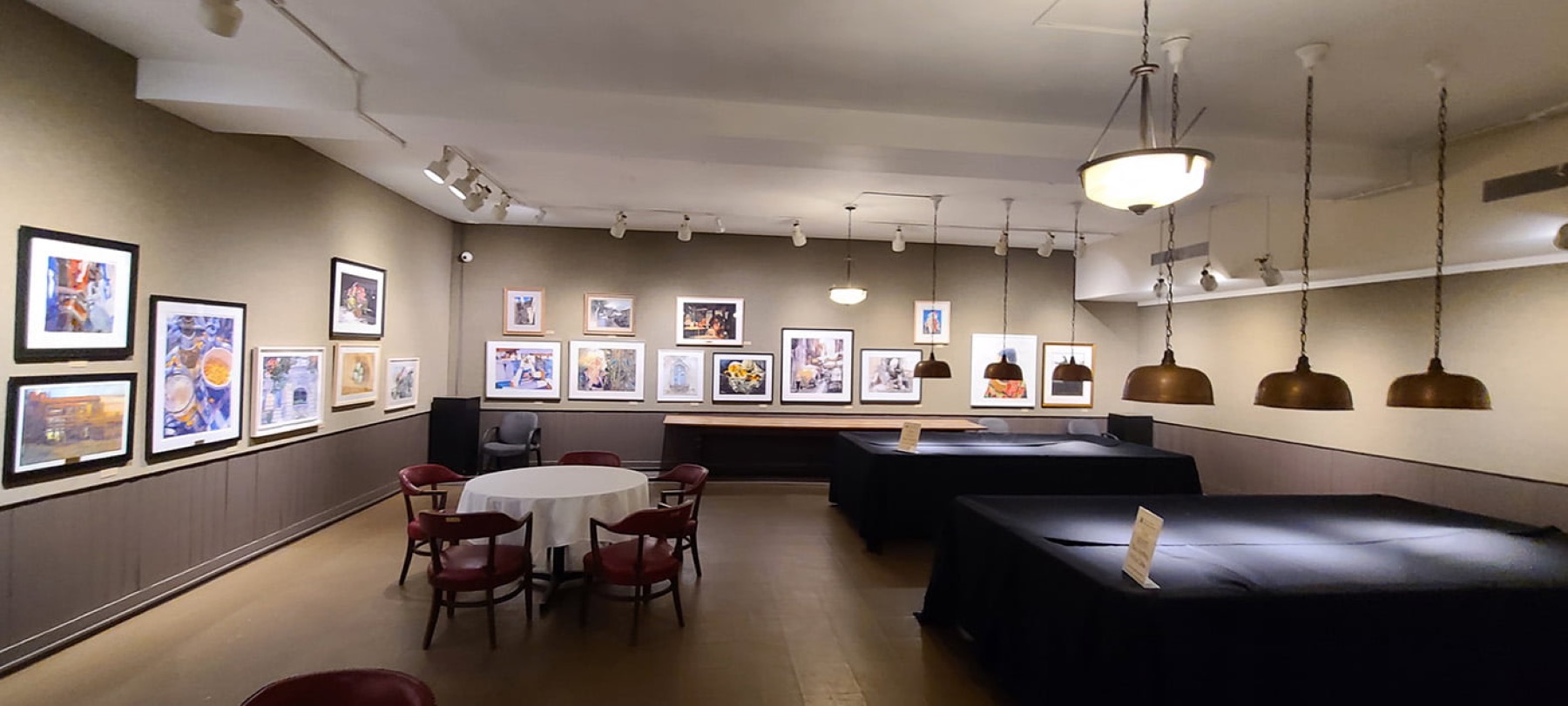 Lower-level Rockwell Gallery with framed artworks and tables along the walls