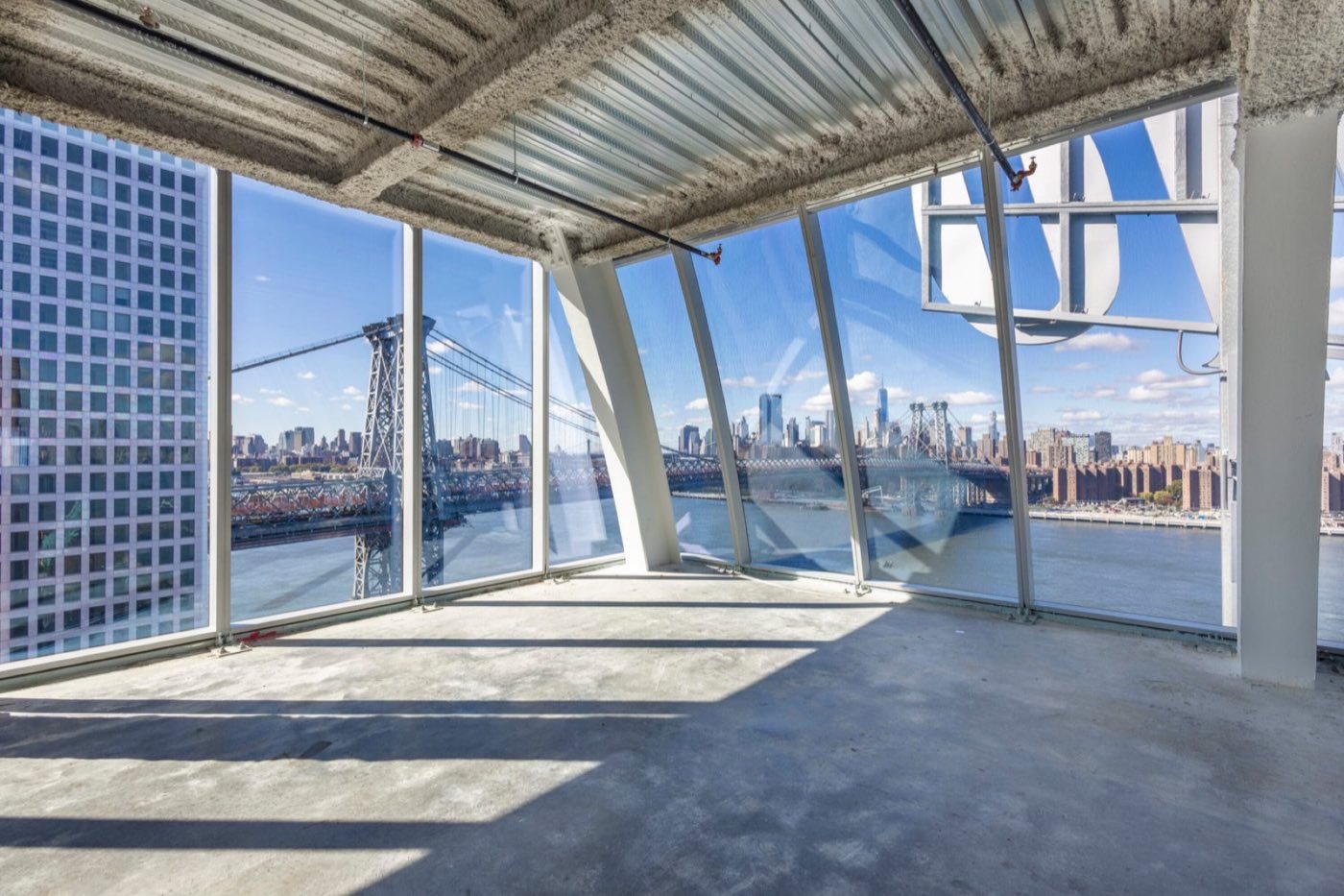 Unfinished level beneath the dome with curved glass walls and bridge views