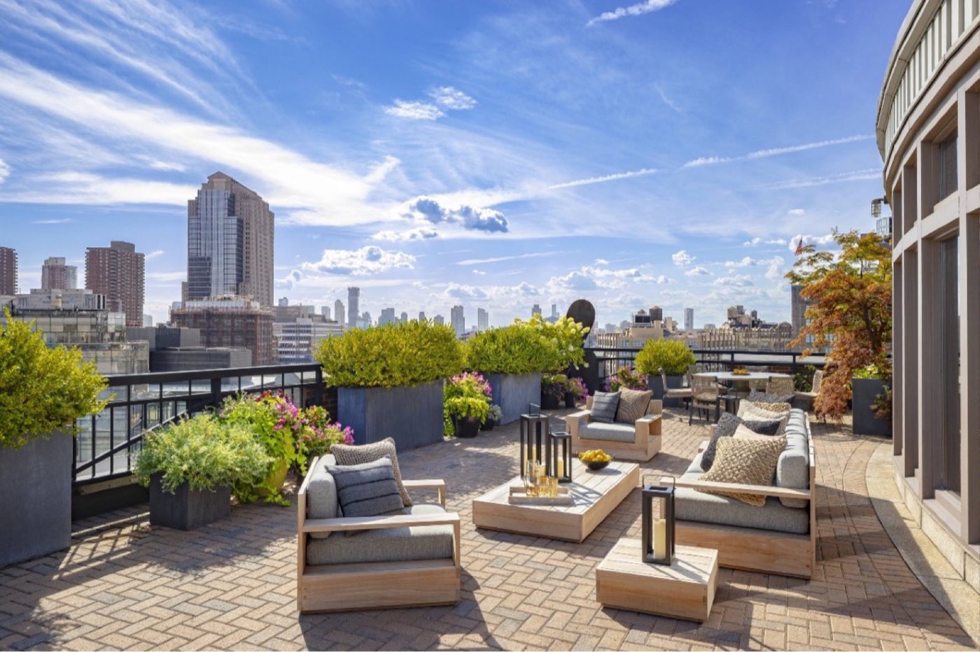 Loft south terrace with outdoor sofas, planters and a view of the downtown skyline