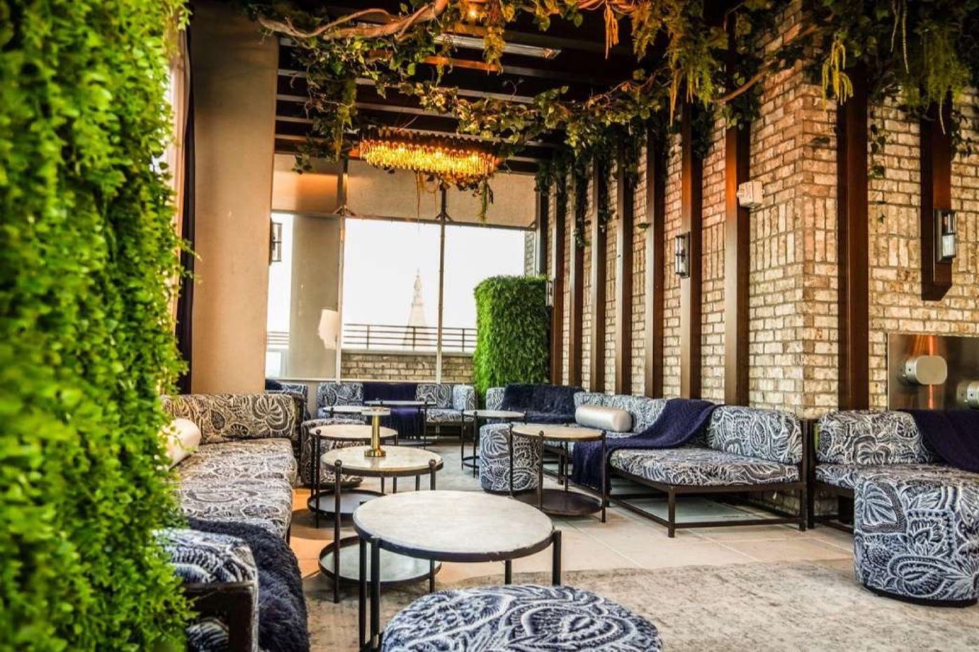 Winter enclosure lounge with greenery walls and patterned seating