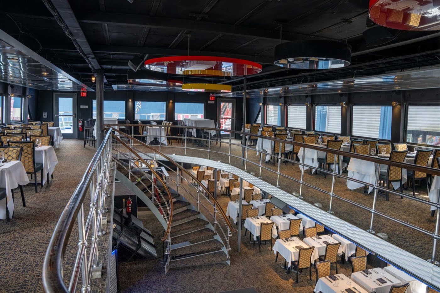 Upper deck balcony and staircase looking down into the two-level dining atrium