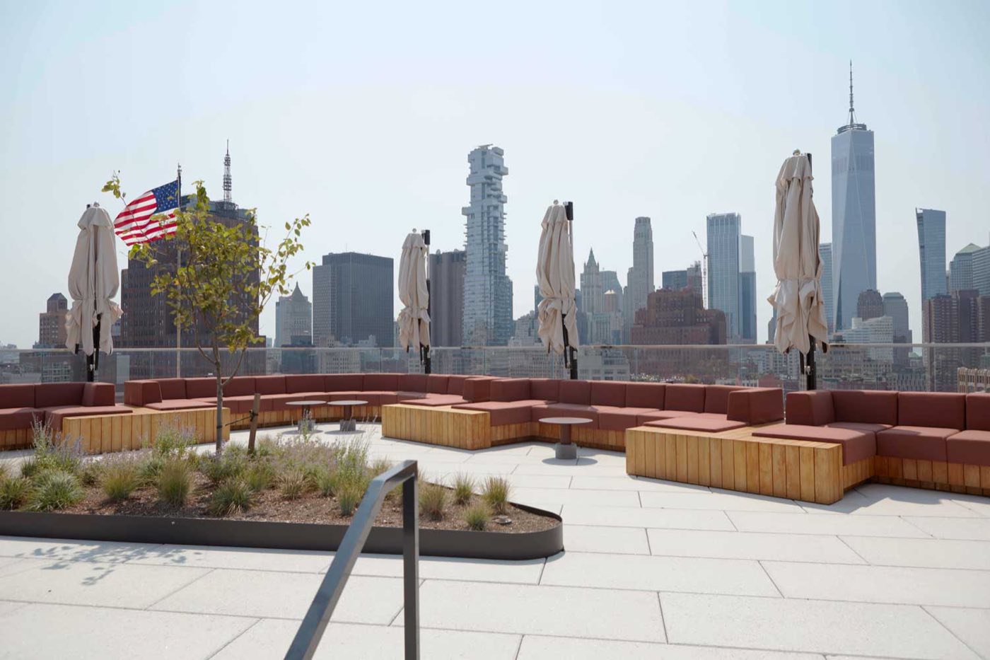 Rooftop terrace with built-in wood seating and the downtown skyline