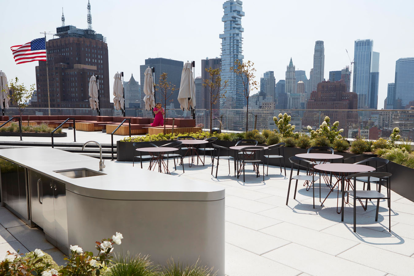 Roof bar counter with cafe tables and skyline views