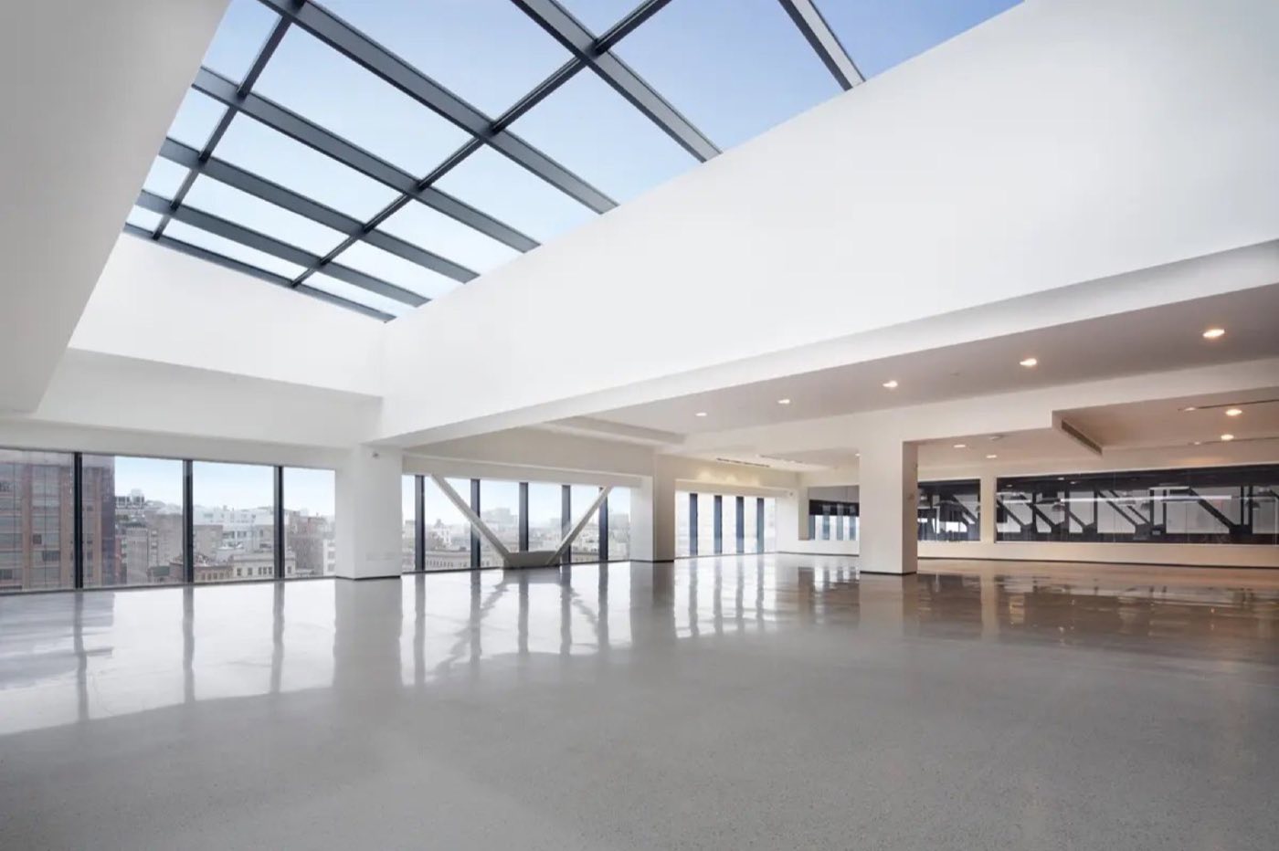 Bright South Mezzanine with skylights, white walls and pale floors
